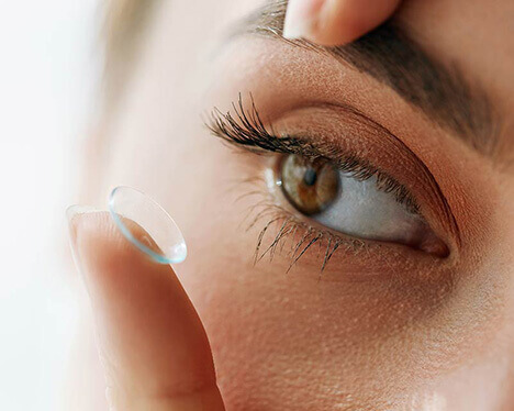 Woman putting contact lens in
